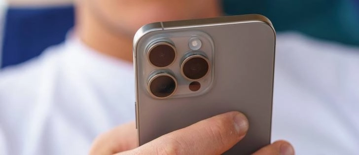 iphone 15 pro max review showing natural titanium finish and camera layout